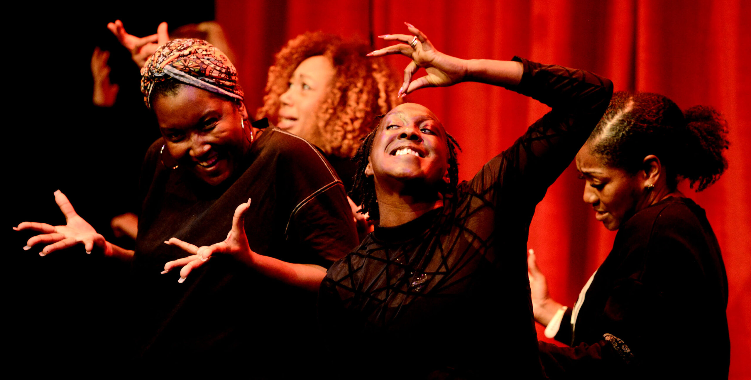Four Black women are telling a story in a theatre